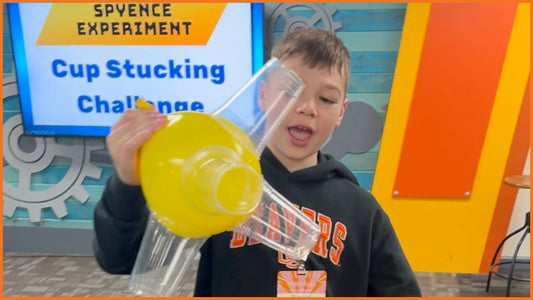 Child participating in hands-on Bible science experiment from Spyence