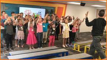 Kids engaged in a fast-paced, teacher-led, interactive Spyence curriculum lesson