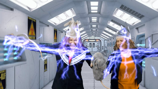 A screencap from one of the Bible intro videos showing two superheroes withstanding a charge of electricity